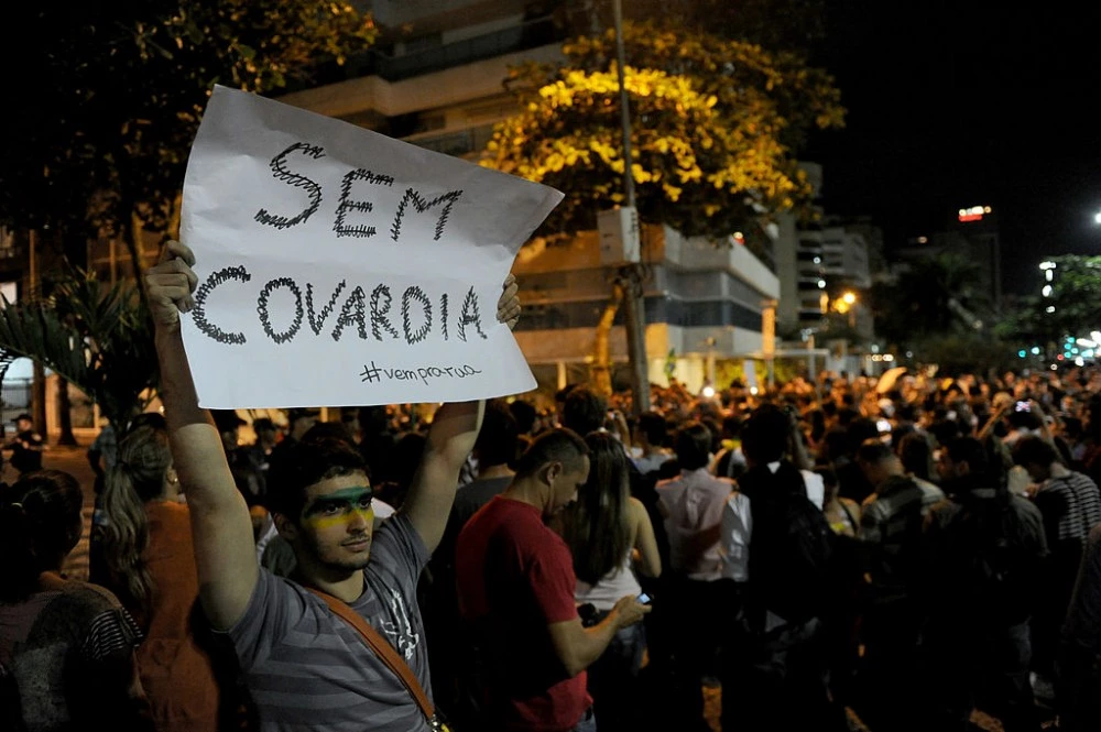 People gather to protest before the house of Rio de Janeiro governor Sergio Cabral in Leblon, Rio de Janeiro, Brazil on June 21, 2013. The 2014 World Cup must be held in Brazil, FIFA secretary general Jerome Valcke said Friday, one day after more than one million people marched in protests across the country. ages of the destruction in Rio after hours of violent protest on the night of June 20th.  AFP PHOTO / TASSO MARCLEO        (Photo credit should read TASSO MARCELO/AFP/Getty Images)
