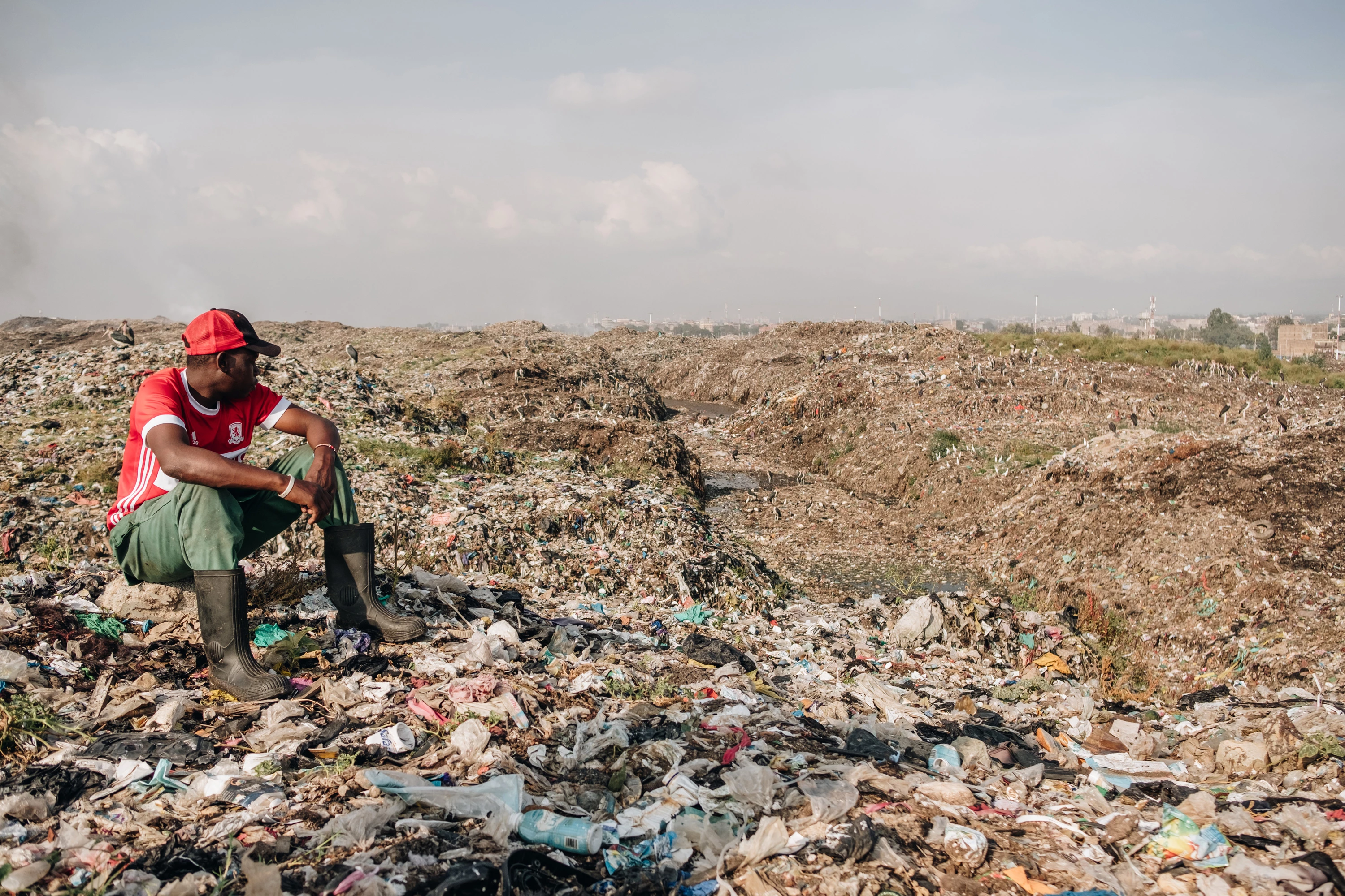 Mwangi Mboya overlooks the hills of Dandora Municiple Dump Site in Nairobi, Kenya. "I grew up here. These people are my family." Feb. 29, 2020. (Khadija Farah for The Intercept).