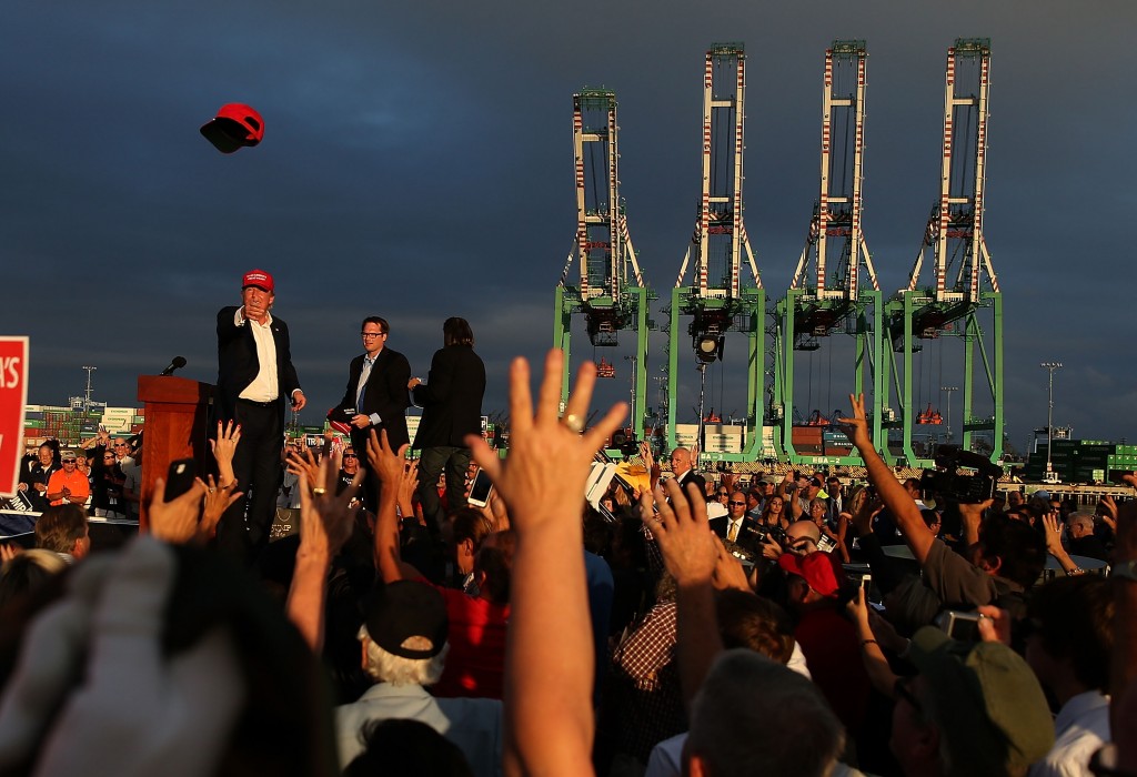 LOS ANGELES, CA - SEPTEMBER 15: Republican presidential candidate Donald Trump (L) throws a hat to supporters during a campaign rally aboard the USS Iowa on September 15, 2015 in Los Angeles, California. Donald Trump is campaigning in Los Angeles a day ahead of the CNN GOP debate that will be broadcast from the Ronald Reagan Presidential Library in Simi Valley. (Photo by Justin Sullivan/Getty Images)