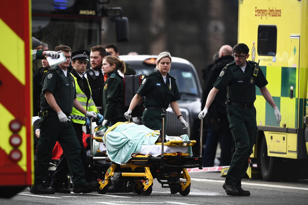 LONDON, ENGLAND - MARCH 22: A member of the public is treated by emergency services near Westminster Bridge and the Houses of Parliament on March 22, 2017 in London, England. A police officer has been stabbed near to the British Parliament and the alleged assailant shot by armed police. Scotland Yard report they have been called to an incident on Westminster Bridge where several people have been injured by a car. (Photo by Carl Court/Getty Images)