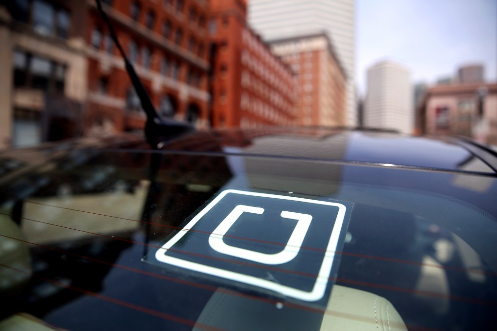 BOSTON - APRIL 22: Uber driver Dean Johnson waits for a customer outside South Station in Boston on April 22, 2016. (Photo by Craig F. Walker/The Boston Globe via Getty Images)