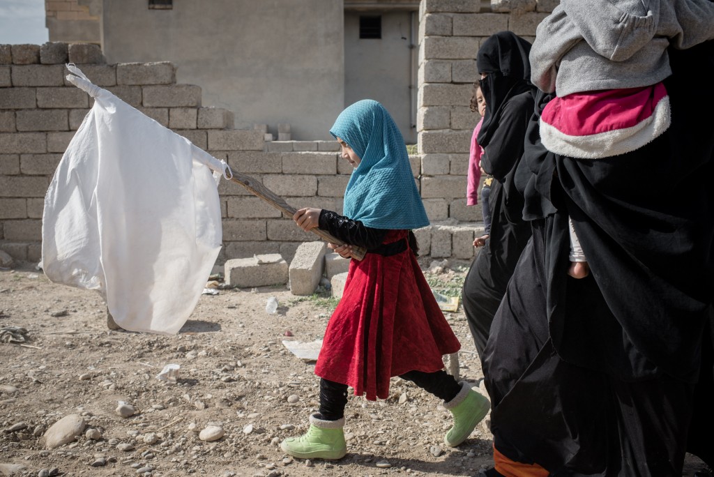 Newly displaced civilians fleeing the conflict between the Iraqi army and ISIS arrive at a mustering area on the northern edge of Gogjali in Mosul, Iraq on Nov. 4, 2016.