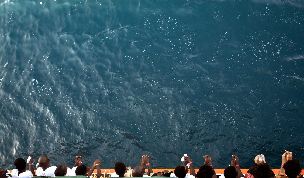 FILE - A Friday, Sept. 1, 2017 file photo of African migrants who were rescued from the Mediterranean Sea north of the Libyan coast, looking from the deck as the Aquarius vessel of SOS Mediterranee and MSF (Doctors Without Borders) NGOs, approaches the port of Pozzallo on Sicily, Italy. The United Nations’ children’s and migration agencies said Tuesday, Sept. 12, 2017 that more than three in four of the migrants aged 14-24 report being subjected to forced labor, sexual abuse and other forms of exploitation while attempting to cross the Mediterranean Sea from Libya to Italy. (AP Photo/Darko Bandic, File)