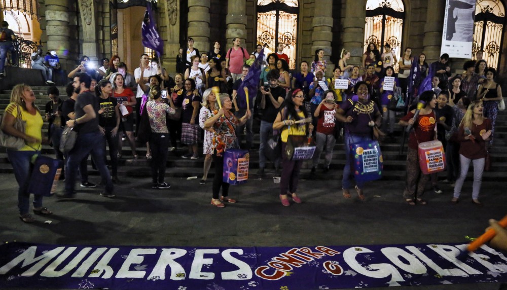 Women protest against the president of the Brazilian lower house Eduardo Cunha, Brazilian Vice-President Michel Temer and Jair Bolsonaro -a far right member of Congress who has praised Brazil's former military dictatorship and torture of opponents in the 1970s- in front of a banner reading "Women against the coup" in Sao Paulo, Brazil on April 26, 2016. Six out of 10 Brazilians want snap elections to resolve the country's political crisis in which leftist President Dilma Rousseff faces impeachment, a poll released Tuesday said. / AFP / Miguel Schincariol (Photo credit should read MIGUEL SCHINCARIOL/AFP/Getty Images)