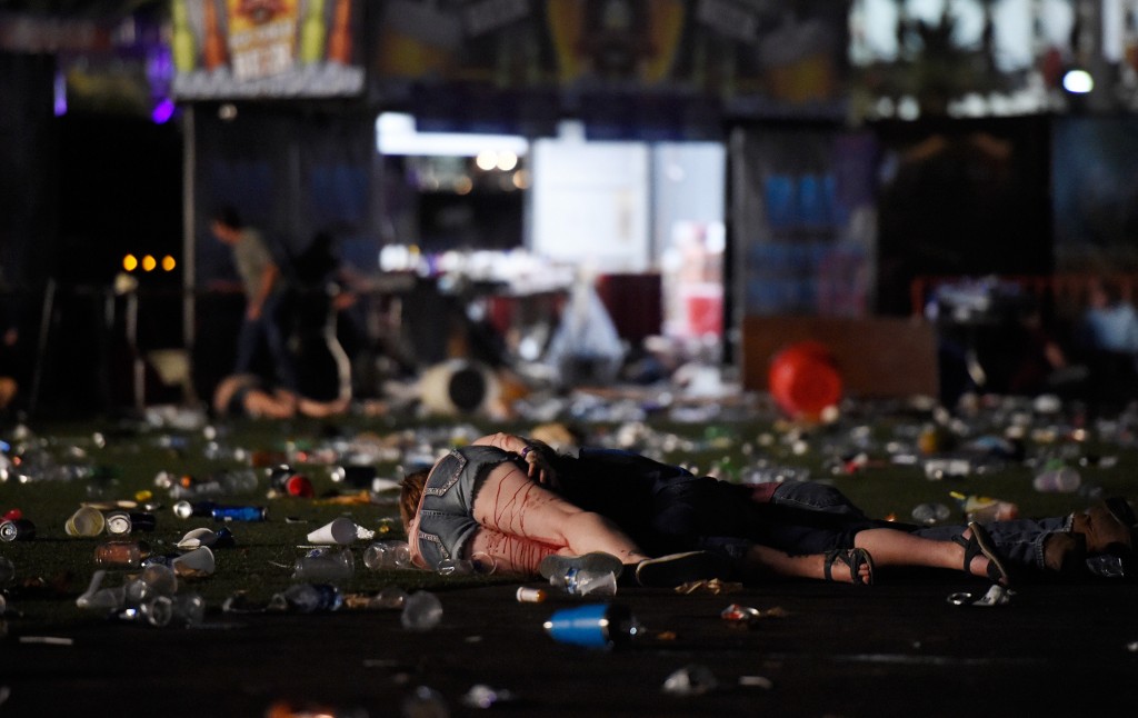 LAS VEGAS, NV - OCTOBER 01: (EDITORS NOTE: Image contains graphic content.) A person lies on the ground covered with blood at the Route 91 Harvest country music festival after apparent gun fire was heard on October 1, 2017 in Las Vegas, Nevada. There are reports of an active shooter around the Mandalay Bay Resort and Casino. (Photo by David Becker/Getty Images)