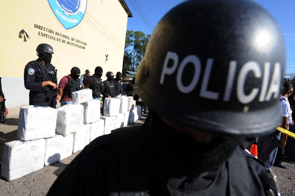 Police officers from the anti-drug squad in Tegucigalpa on October 7, 2010 look after a load of 500 kilos of cocaine seized from traffickers during a joint operation by the Honduran Police, the Army and the US Drug Enforcement Administration (DEA), in Brus Laguna, Mosquitia, Honduras.  AFP PHOTO/Orlando SIERRA (Photo credit should read ORLANDO SIERRA/AFP/Getty Images)